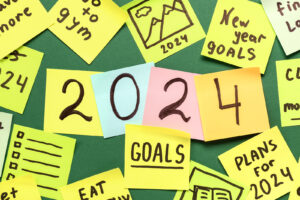 Sticky Notes With Different Goals For 2024 On Green Background