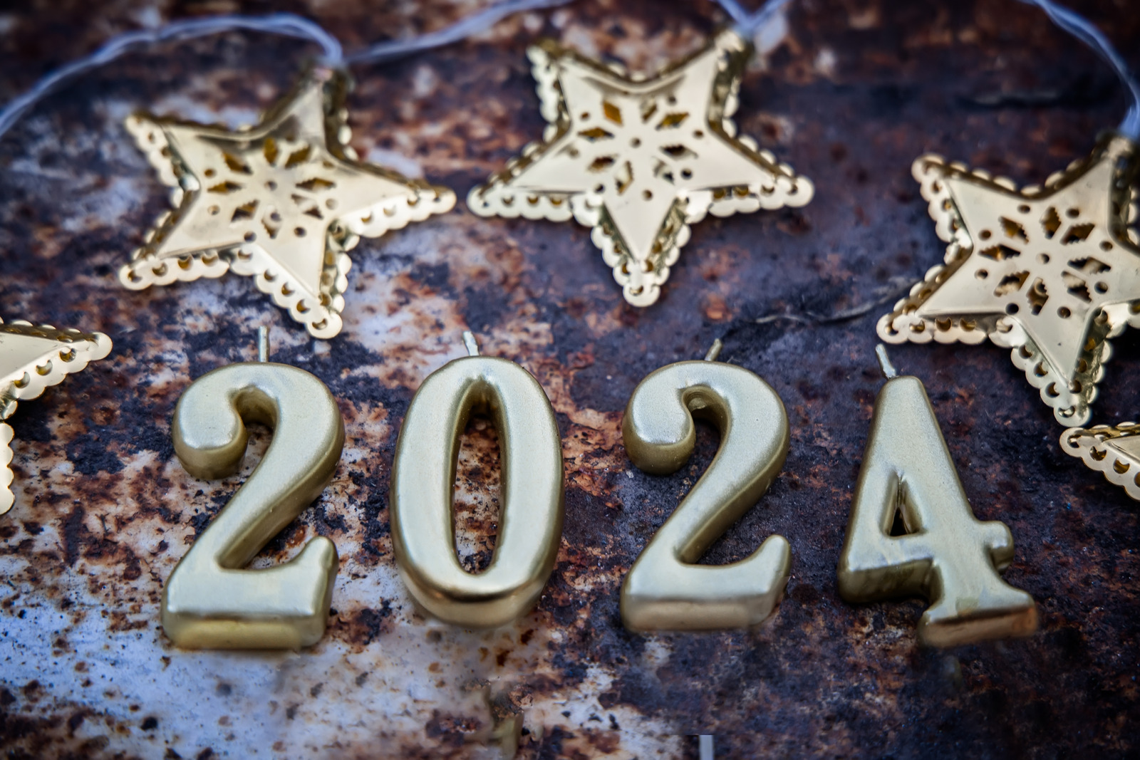 Canva 2024. Coming New Year. Numbers On Rusty Background With Gold Stars
