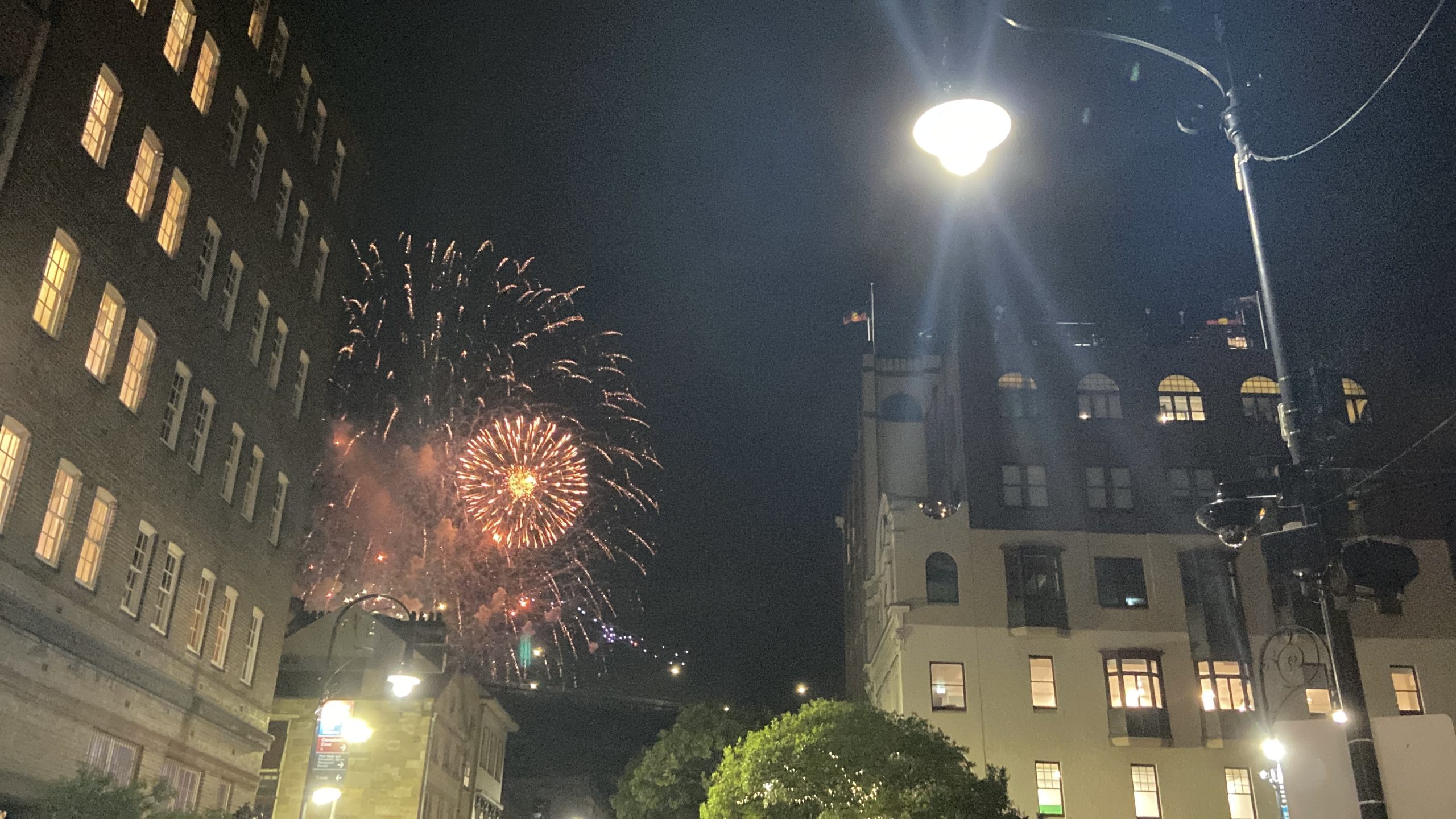 New Year fireworks exploding between the old buildings of a European city square