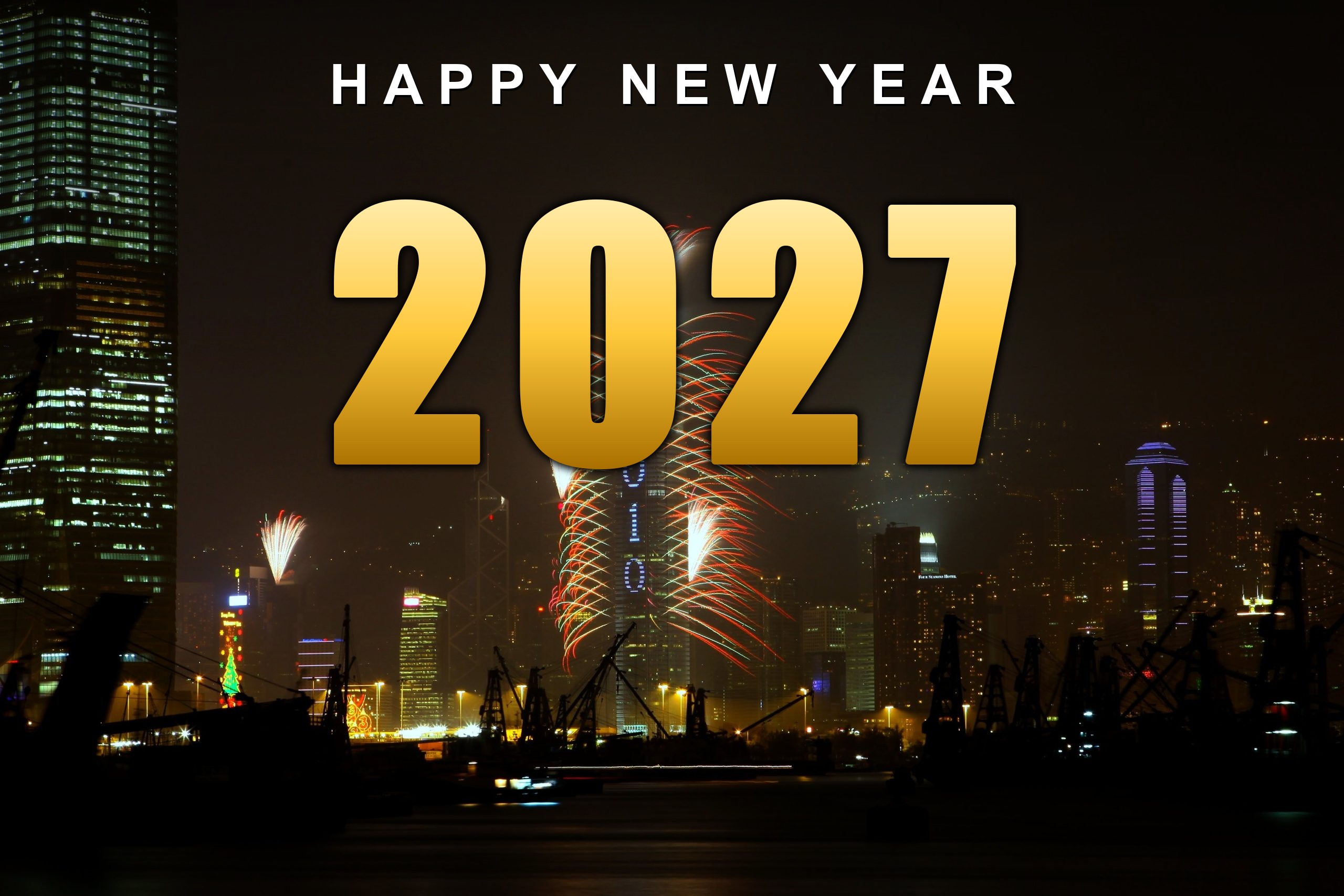 Happy New Year 2027 in gold lettering over a city skyline fireworks show
