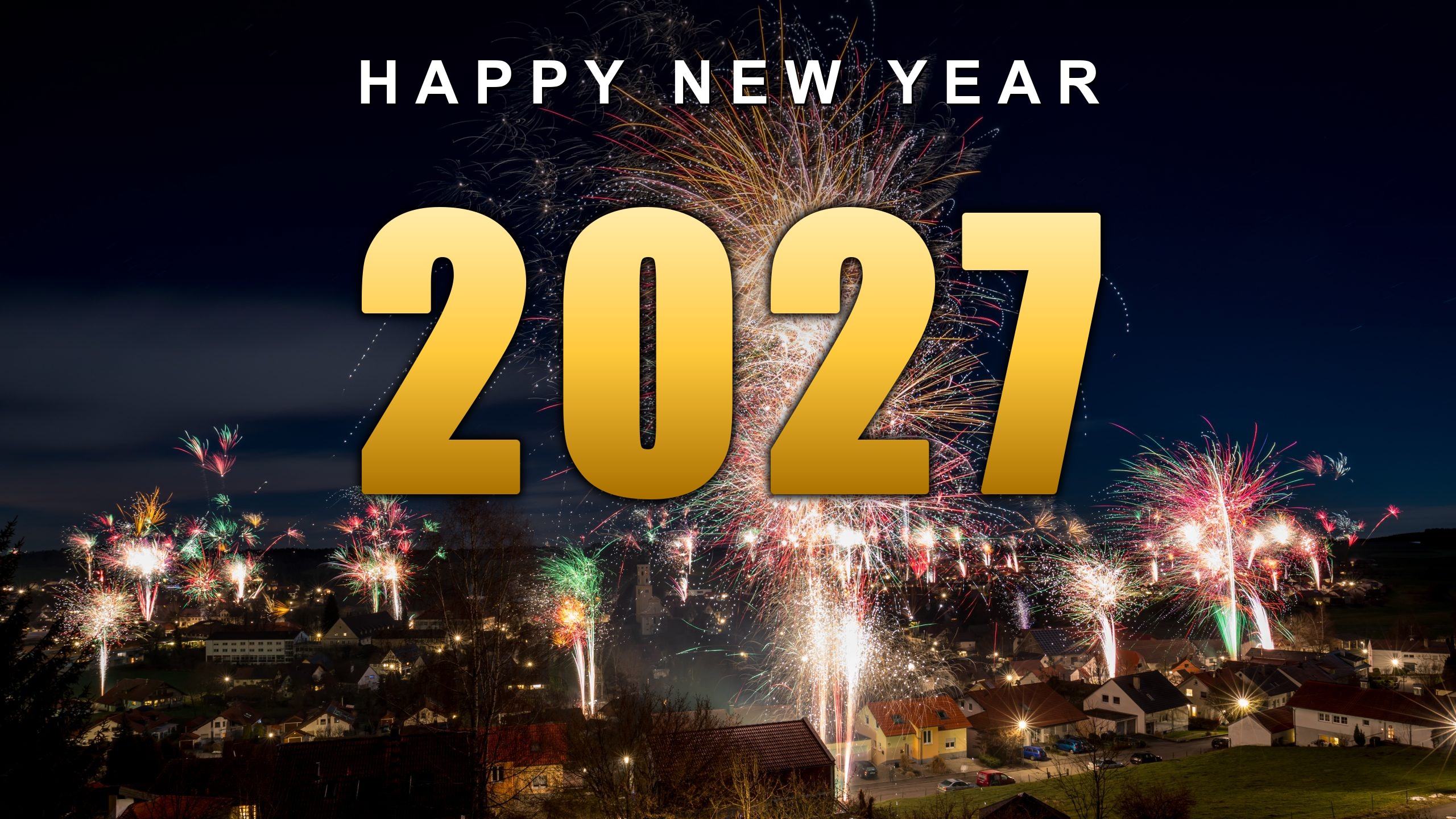 Happy New Year 2027 in gold lettering over a village fireworks display