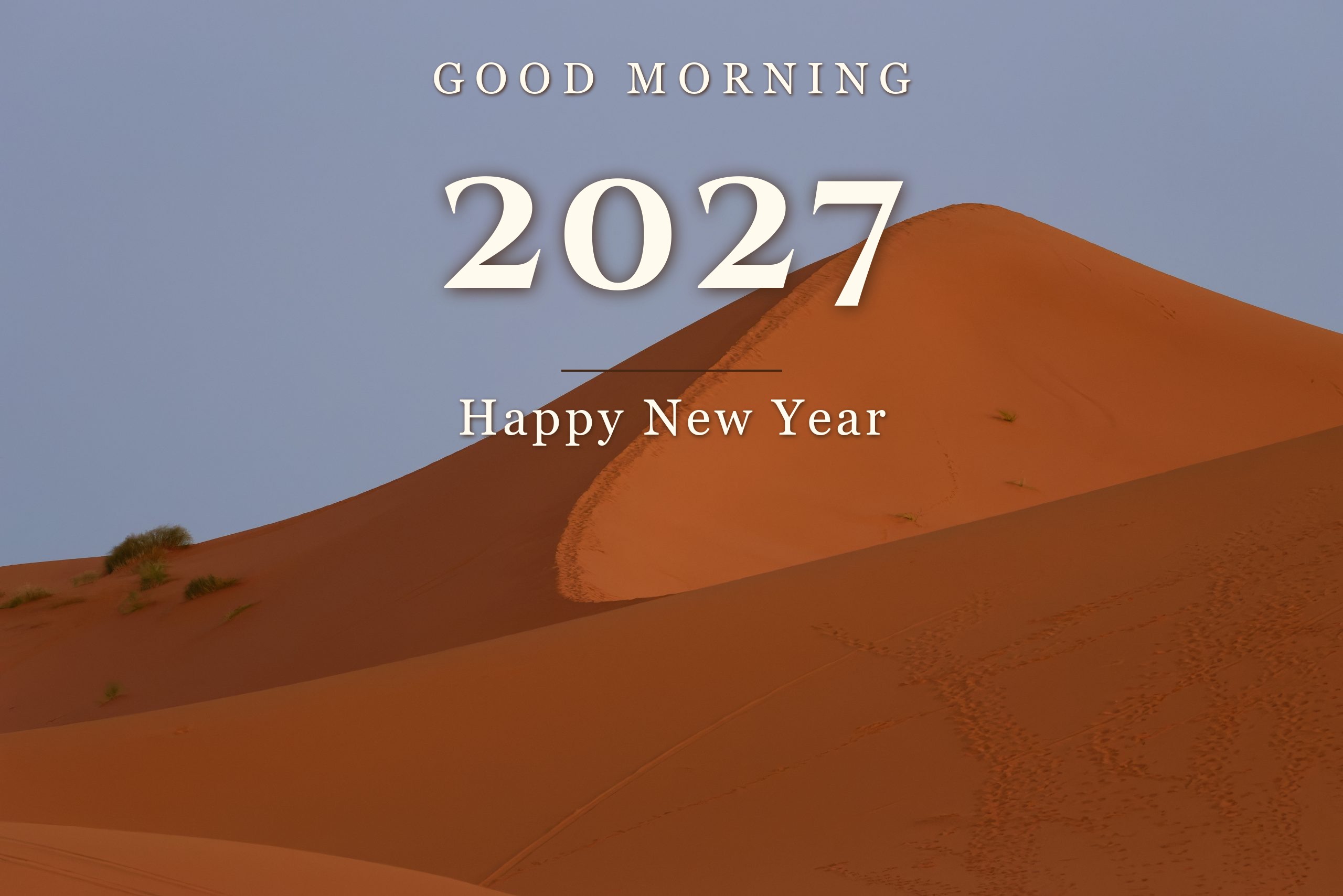 ivas1a Good Morning Happy New Year 2027 in minimal serif over desert dunes at sunrise